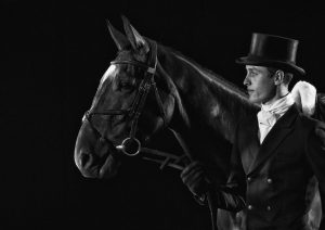 Eventer with horse in dressage top hat and tails